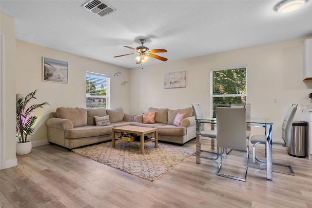 500 W Oakland Ave, Oakland, FL 34760 - living area with light wood finished floors, a ceiling fan, and baseboards