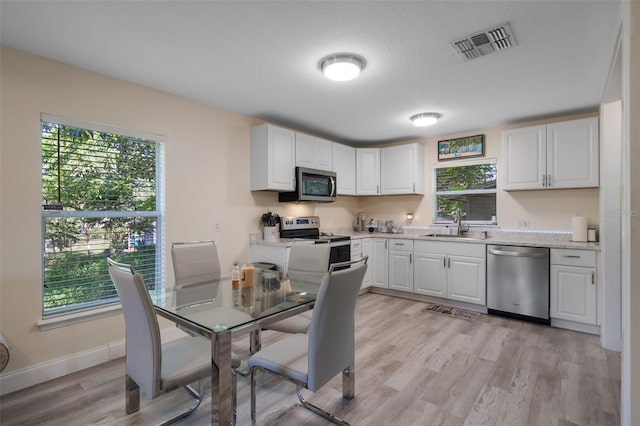 500 W Oakland Ave, Oakland, FL 34760 - kitchen with appliances with stainless steel finishes, light countertops, a sink, and healthy amount of natural light