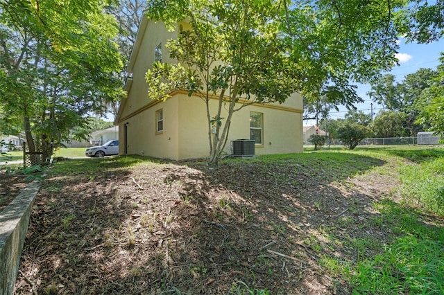 500 W Oakland Ave, Oakland, FL 34760 - view of property exterior featuring stucco siding and central AC unit