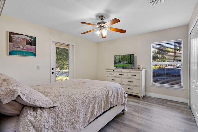 500 W Oakland Ave, Oakland, FL 34760 - bedroom with light wood-style flooring, access to outside, baseboards, and a ceiling fan