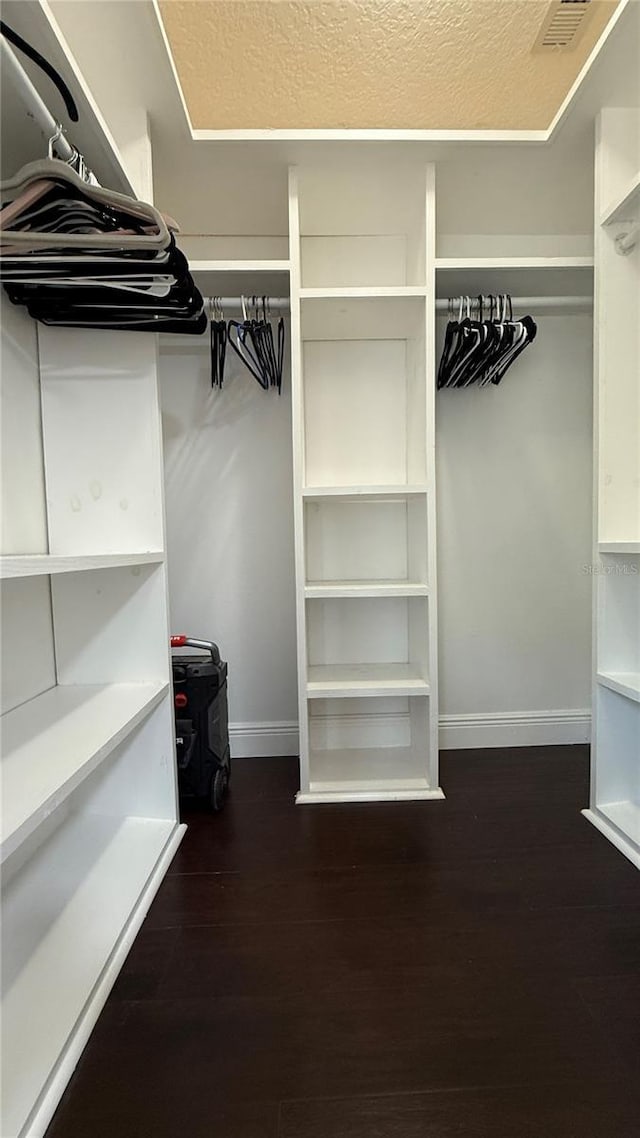 6428 Lynn Rd, Orlando, FL 32810 - walk in closet with dark wood-style flooring