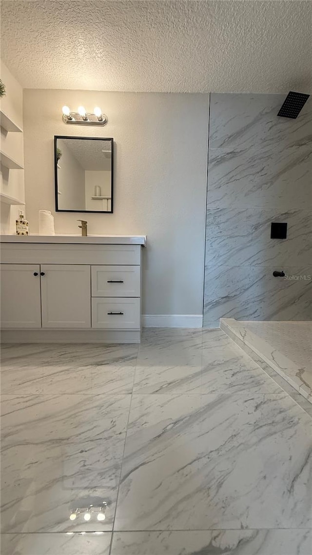 6428 Lynn Rd, Orlando, FL 32810 - full bath featuring marble finish floors, a marble finish shower, vanity, a textured ceiling, and baseboards