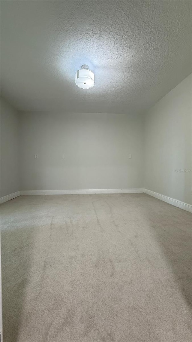 6428 Lynn Rd, Orlando, FL 32810 - carpeted empty room with a textured ceiling and baseboards