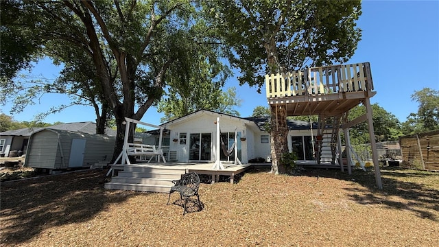 6428 Lynn Rd, Orlando, FL 32810 - rear view of house with a wooden deck and stairway