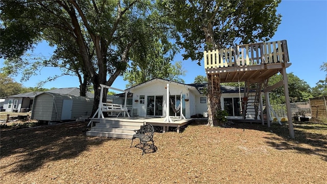 6428 Lynn Rd, Orlando, FL 32810 - back of house with a wooden deck and stairs