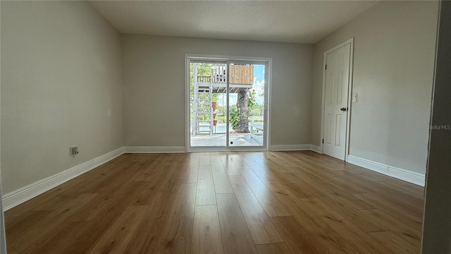 6428 Lynn Rd, Orlando, FL 32810 - empty room with wood finished floors and baseboards