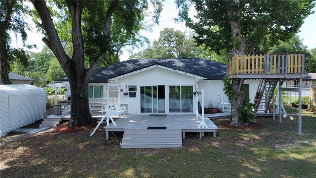 6428 Lynn Rd, Orlando, FL 32810 - rear view of house featuring a wooden deck, roof with shingles, stucco siding, and stairs