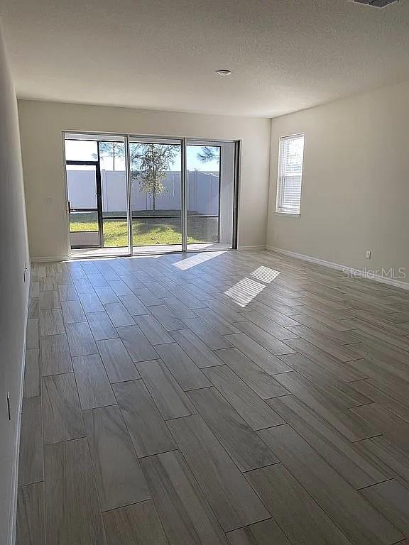 605 Big Pine Ave, Minneola, FL 34715 - unfurnished room featuring wood finished floors and baseboards