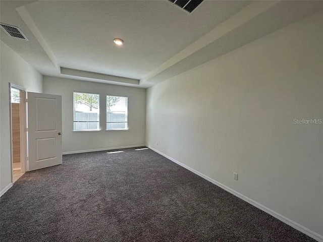 605 Big Pine Ave, Minneola, FL 34715 - unfurnished room with baseboards, dark carpet, and plenty of natural light
