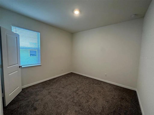 605 Big Pine Ave, Minneola, FL 34715 - unfurnished room featuring dark carpet and baseboards