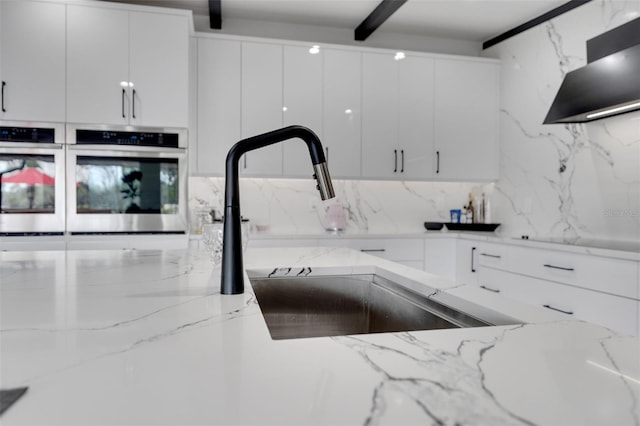 1700 Lake Markham Rd, Sanford, FL 32771 - kitchen with ventilation hood, decorative backsplash, white cabinets, and a sink