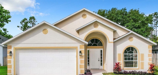 2124 Fish Eagle St, Clermont, FL 34714 - view of front of home featuring stucco siding, an attached garage, and concrete driveway