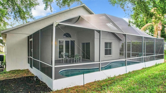 2124 Fish Eagle St, Clermont, FL 34714 - back of property featuring a patio, an outdoor pool, stucco siding, and glass enclosure