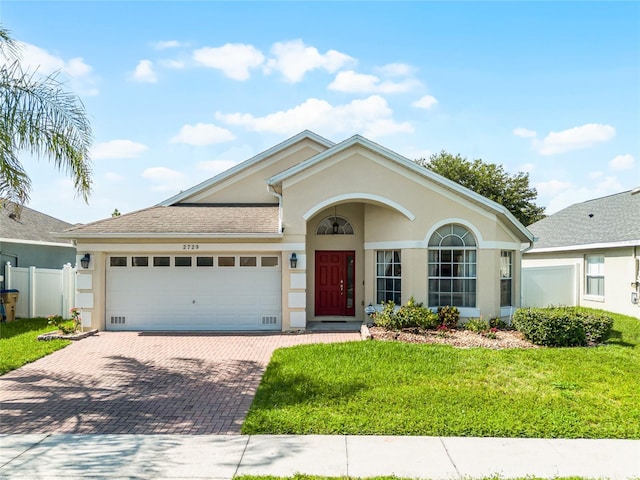 2729 Stanwood Dr, Kissimmee, FL 34743 - ranch-style home with stucco siding, decorative driveway, and an attached garage