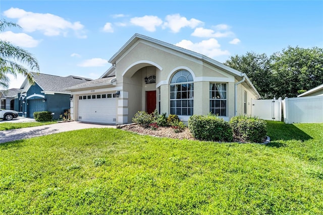2729 Stanwood Dr, Kissimmee, FL 34743 - ranch-style home with stucco siding, an attached garage, and driveway