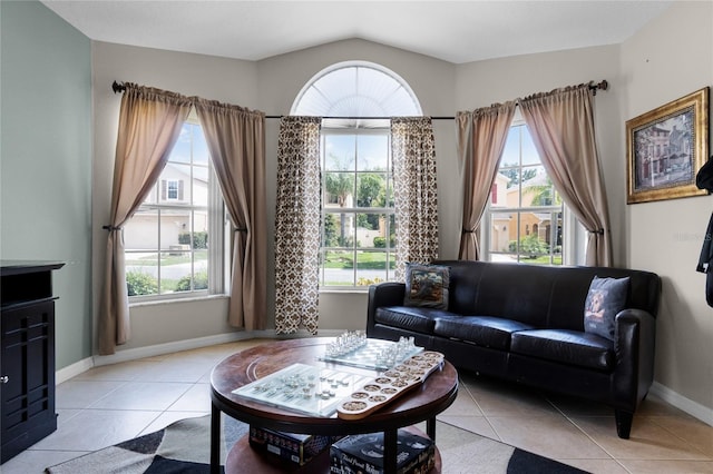 2729 Stanwood Dr, Kissimmee, FL 34743 - living room with light tile patterned flooring, baseboards, and vaulted ceiling