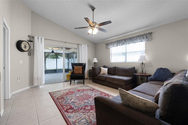 2729 Stanwood Dr, Kissimmee, FL 34743 - living area featuring light tile patterned flooring, healthy amount of natural light, lofted ceiling, ceiling fan, and a textured ceiling