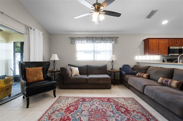 2729 Stanwood Dr, Kissimmee, FL 34743 - living room with light tile patterned floors, a ceiling fan, lofted ceiling, a textured ceiling, and recessed lighting