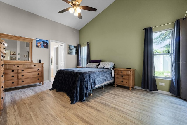 2729 Stanwood Dr, Kissimmee, FL 34743 - bedroom with high vaulted ceiling, light wood-type flooring, ceiling fan, baseboards, and ensuite bath