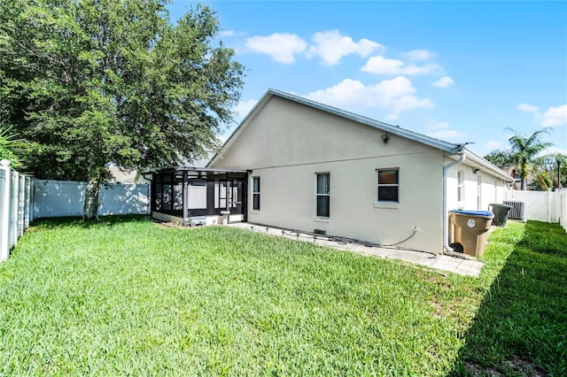 2729 Stanwood Dr, Kissimmee, FL 34743 - back of property with a sunroom, stucco siding, and cooling unit