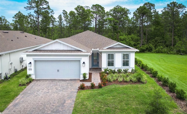 2479 Pine Preserve Ct, Saint Cloud, FL 34771 - single story home with roof with shingles, a garage, driveway, a front yard, and stucco siding