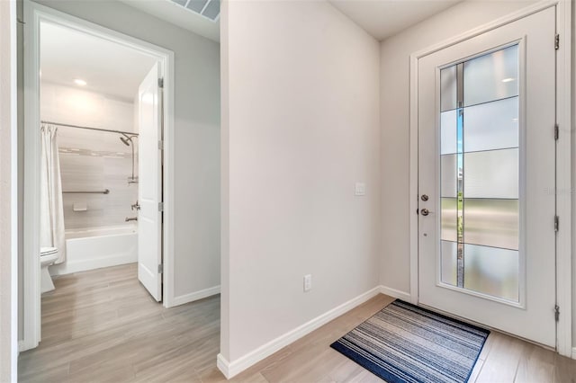 2479 Pine Preserve Ct, Saint Cloud, FL 34771 - doorway to outside featuring baseboards and light wood-style flooring