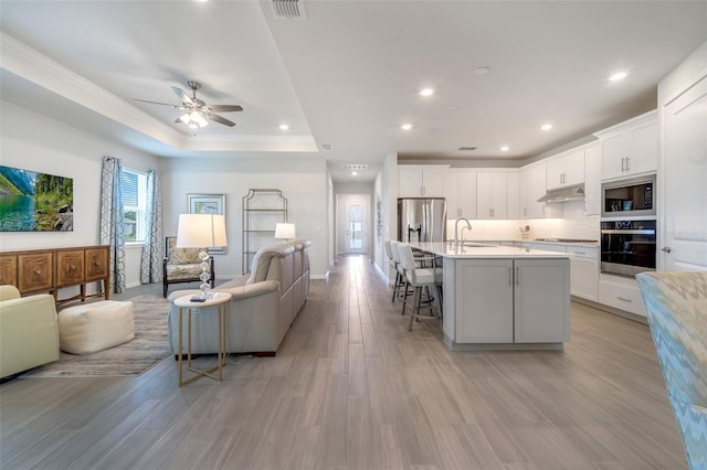 2479 Pine Preserve Ct, Saint Cloud, FL 34771 - living area with a ceiling fan, light wood-style flooring, baseboards, recessed lighting, and ornamental molding