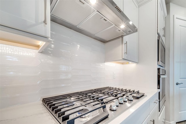 2479 Pine Preserve Ct, Saint Cloud, FL 34771 - kitchen with wall chimney range hood, stainless steel appliances, white cabinets, and light stone counters