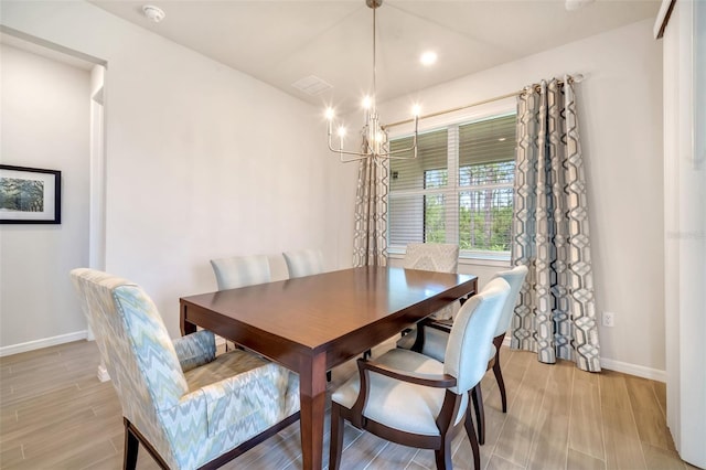 2479 Pine Preserve Ct, Saint Cloud, FL 34771 - dining area with baseboards, a chandelier, and light wood-style floors