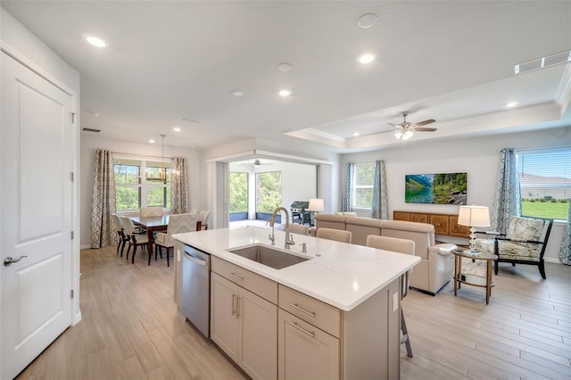 2479 Pine Preserve Ct, Saint Cloud, FL 34771 - kitchen featuring dishwasher, a sink, open floor plan, light countertops, and a kitchen island with sink