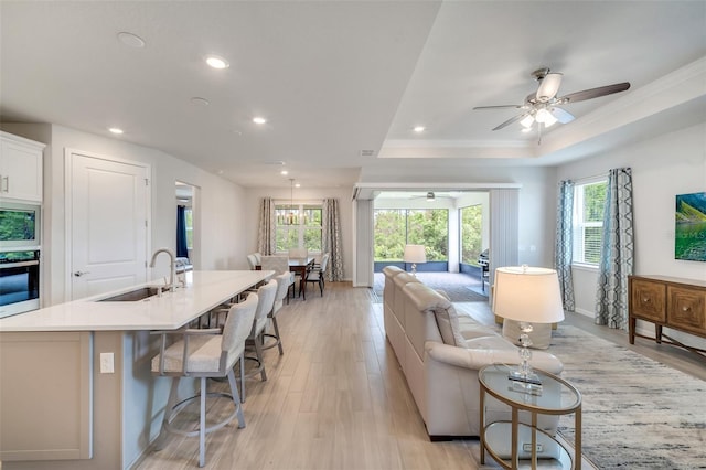 2479 Pine Preserve Ct, Saint Cloud, FL 34771 - living area featuring ceiling fan, light wood-type flooring, recessed lighting, a raised ceiling, and baseboards