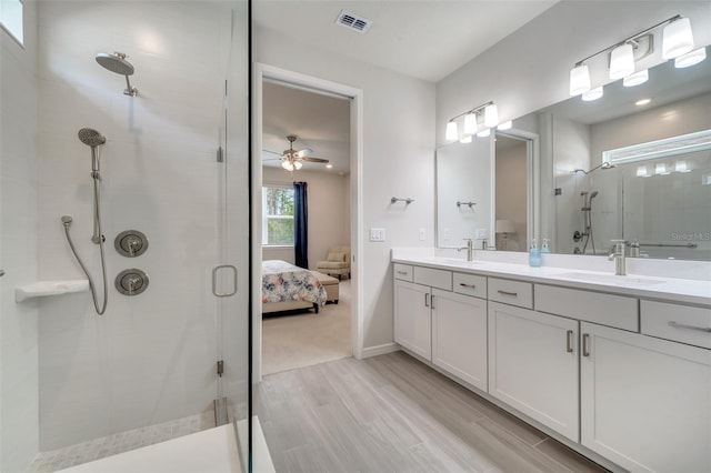 2479 Pine Preserve Ct, Saint Cloud, FL 34771 - ensuite bathroom with a stall shower, double vanity, wood finished floors, and a ceiling fan