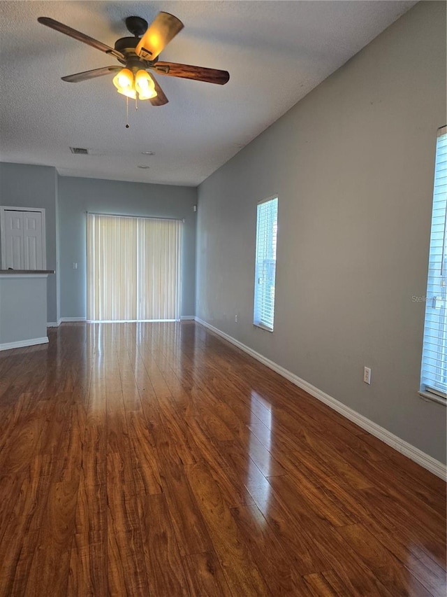 1754 Fritwell Ct, Ocoee, FL 34761 - empty room featuring dark wood-type flooring, a ceiling fan, and baseboards