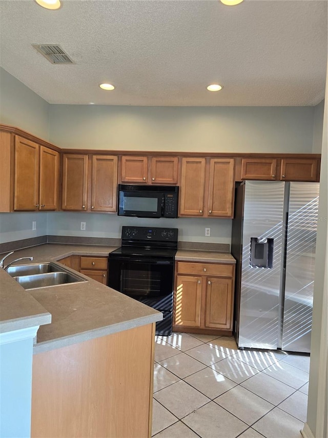 1754 Fritwell Ct, Ocoee, FL 34761 - kitchen featuring black appliances, a sink, brown cabinets, recessed lighting, and light tile patterned floors