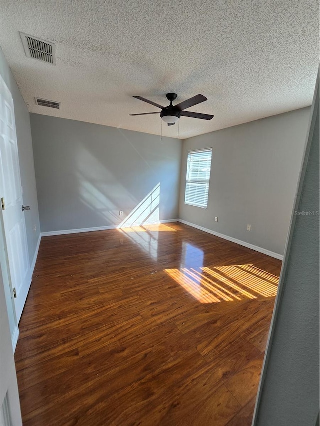 1754 Fritwell Ct, Ocoee, FL 34761 - empty room featuring wood finished floors, a textured ceiling, ceiling fan, and baseboards