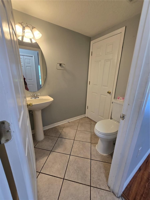 1754 Fritwell Ct, Ocoee, FL 34761 - bathroom featuring toilet, tile patterned flooring, baseboards, and a textured ceiling