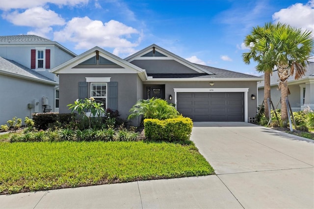 10516 Tranquil Meadow Loop, Riverview, FL 33569 - view of front of home featuring a garage, driveway, stucco siding, and a front lawn