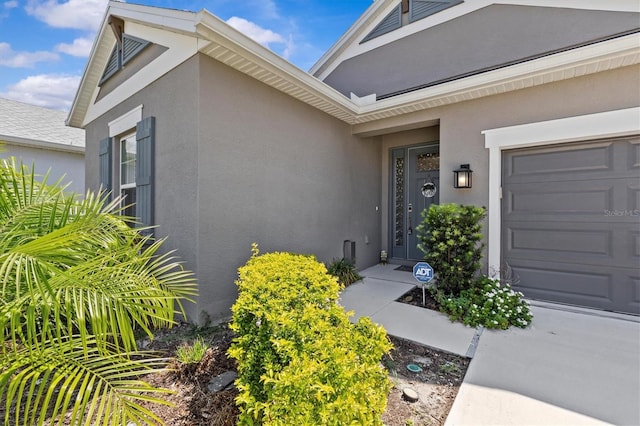 10516 Tranquil Meadow Loop, Riverview, FL 33569 - doorway to property with an attached garage and stucco siding