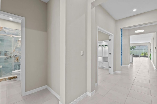 10516 Tranquil Meadow Loop, Riverview, FL 33569 - hallway with light tile patterned floors and baseboards