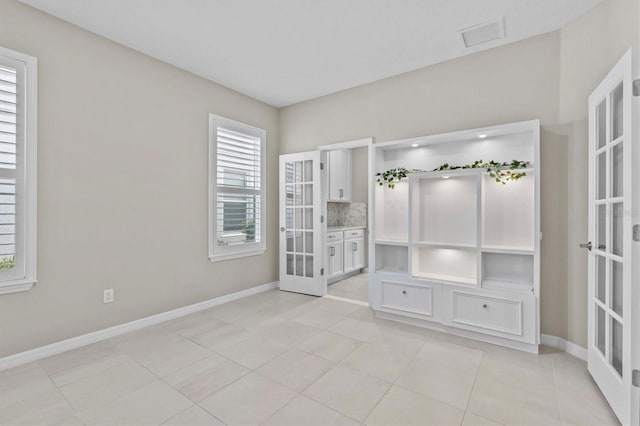 10516 Tranquil Meadow Loop, Riverview, FL 33569 - unfurnished bedroom with french doors, baseboards, and light tile patterned floors