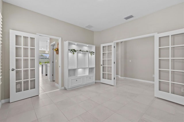 10516 Tranquil Meadow Loop, Riverview, FL 33569 - empty room featuring french doors, light tile patterned flooring, and baseboards