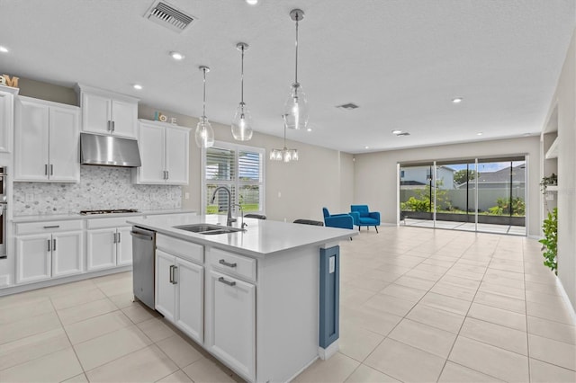10516 Tranquil Meadow Loop, Riverview, FL 33569 - kitchen featuring under cabinet range hood, stainless steel dishwasher, a sink, white gas cooktop, and tasteful backsplash
