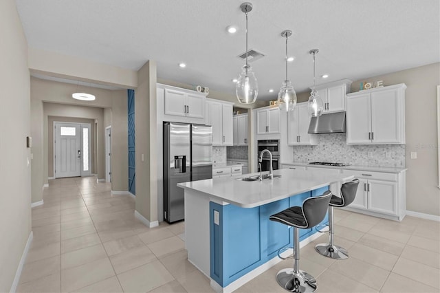 10516 Tranquil Meadow Loop, Riverview, FL 33569 - kitchen with appliances with stainless steel finishes, under cabinet range hood, a sink, decorative backsplash, and recessed lighting