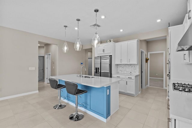 10516 Tranquil Meadow Loop, Riverview, FL 33569 - kitchen with appliances with stainless steel finishes, a sink, backsplash, light countertops, and white cabinetry