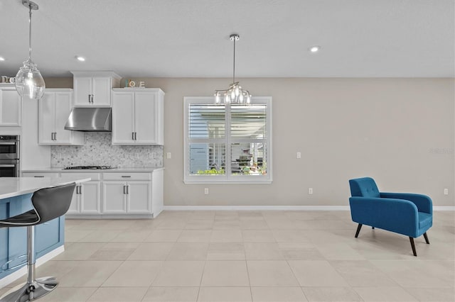 10516 Tranquil Meadow Loop, Riverview, FL 33569 - kitchen featuring under cabinet range hood, light countertops, tasteful backsplash, gas cooktop, and recessed lighting