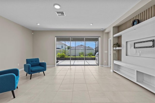 10516 Tranquil Meadow Loop, Riverview, FL 33569 - sitting room featuring light tile patterned floors, baseboards, recessed lighting, and a textured ceiling