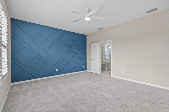 10516 Tranquil Meadow Loop, Riverview, FL 33569 - unfurnished bedroom featuring baseboards, carpet flooring, ceiling fan, a decorative wall, and connected bathroom