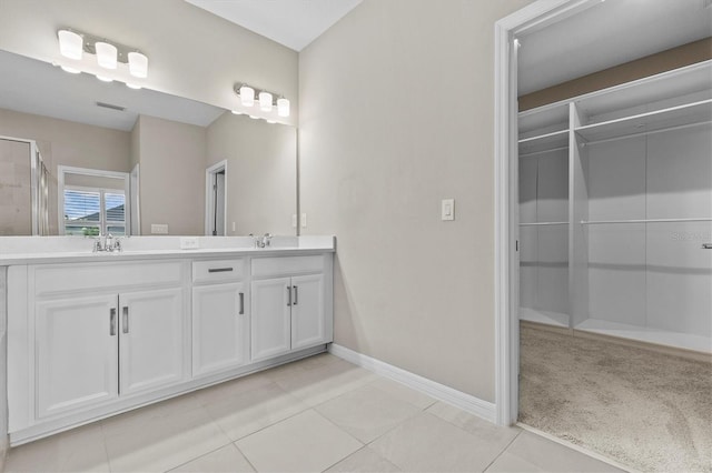 10516 Tranquil Meadow Loop, Riverview, FL 33569 - full bathroom with double vanity, baseboards, tile patterned flooring, and a spacious closet