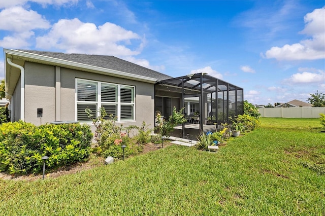 10516 Tranquil Meadow Loop, Riverview, FL 33569 - rear view of property featuring stucco siding, a patio area, glass enclosure, and roof with shingles