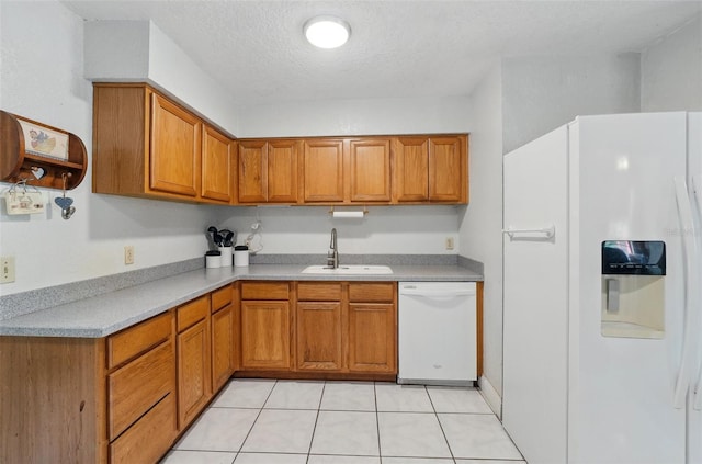 1111 Liberty Ave, Mount Dora, FL 32757 - kitchen featuring white appliances, a sink, brown cabinetry, light countertops, and a textured ceiling